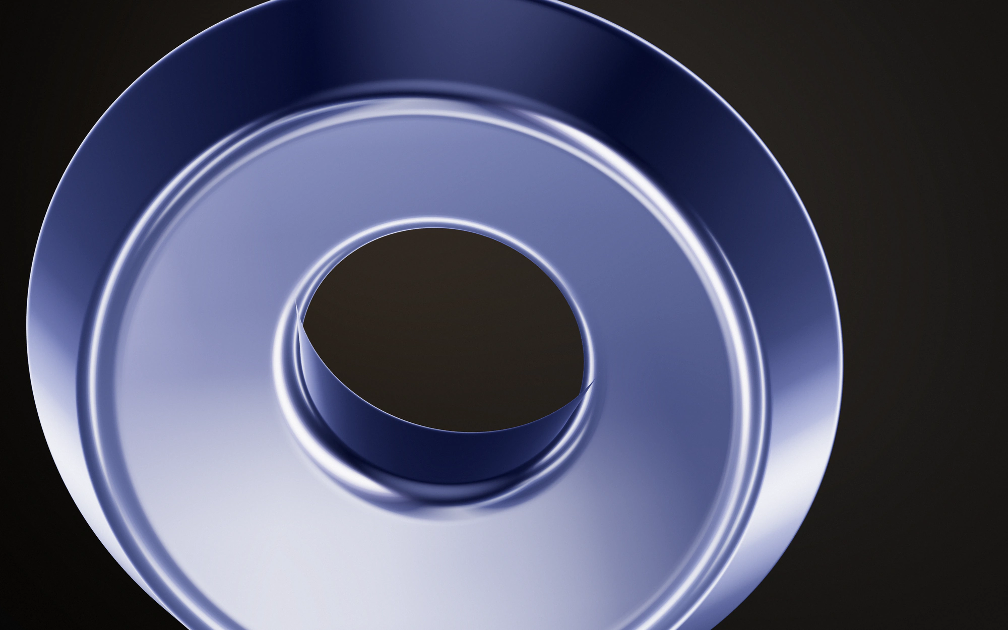 A thick anodised blue ring seen close from below against a warm charcoal background