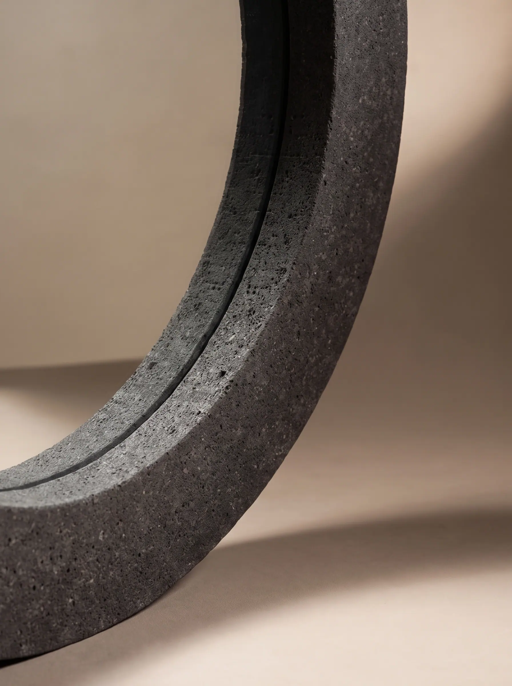 A thick basalt ring with a split groove, close crop