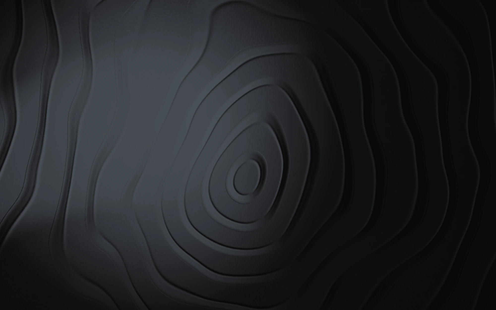 Dark carved topographic relief: concentric stepped contour lines around a raised centre, lit from the left by cool silver light